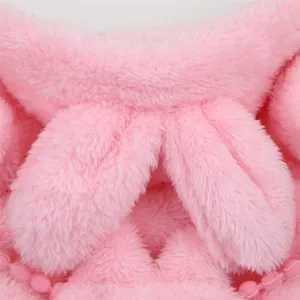 Close-up of pink fluffy pet rabbit costume showing soft fleece texture and pom-pom trim