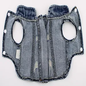 Close-up showing the flat layout and distressed texture of a blue denim pet vest
