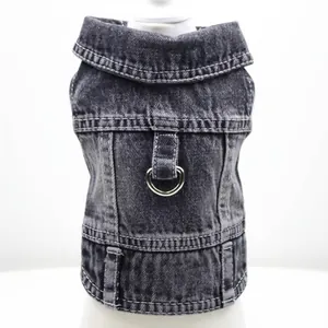 Detail view of a black denim pet vest with a metal D-ring for leash attachment
