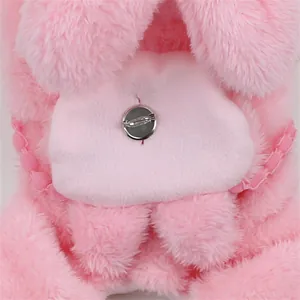 Close-up of pink plush pet jumpsuit showing soft fleece texture and pin detail.