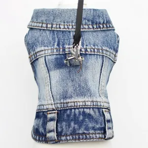 Macro detail of blue denim pet vest showing stitching and metal leash attachment