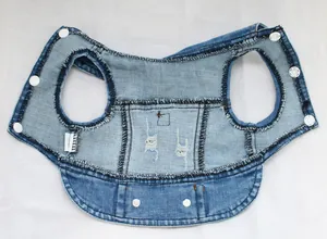 Detailed interior view of a blue pet denim dog vest with white snap buttons on white background