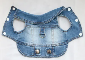 Detailed view of blue denim pet vest with metal D-ring and white snap buttons.