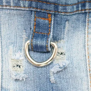 Detail of durable D-ring attachment on light blue distressed pet denim vest