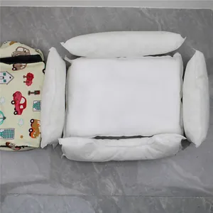 Detail of pet bed components including 5 white pillow inserts and a car patterned cover.