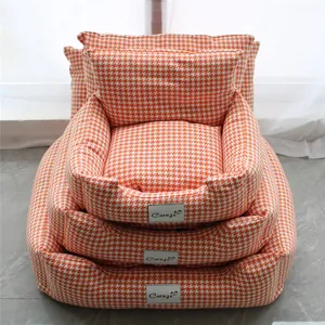 Three nested orange and white houndstooth pet sofa beds for cats and small dogs