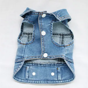 Close-up detail of a blue denim dog vest with sturdy white snap buttons and fine stitching.