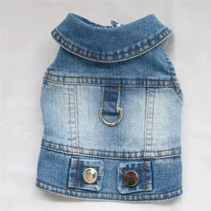 Detail view of blue denim dog vest with integrated metal leash D-ring and buttons