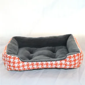 Detailed view of the warm pet bed featuring orange houndstooth fabric and grey plush lining