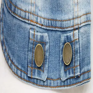 Close-up detail of pet denim vest hem showing durable dual metal traction buckles