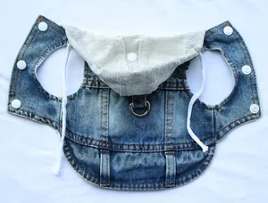Detailed view of denim dog vest with hood and metal D-ring for leash attachment