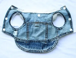 Detailed view of the durable denim fabric and snap buttons on a pet vest