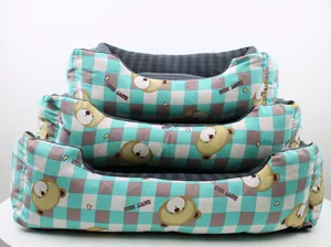 Detail view of three stacked checkered pet beds with cute bear prints in multiple sizes