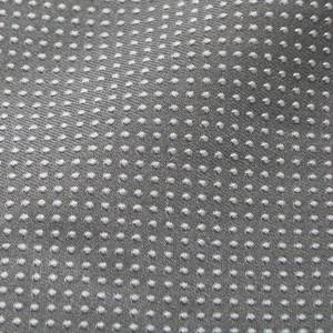 Detailed macro view of the non-slip fabric bottom of a pet bed with rubber dots