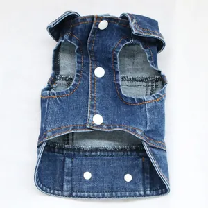 Close-up of a blue denim pet vest with white buttons and orange stitching detail