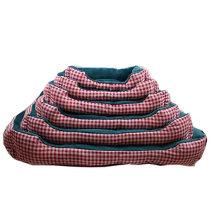 Stacked red gingham pet beds with teal plush lining for dogs and cats in various sizes