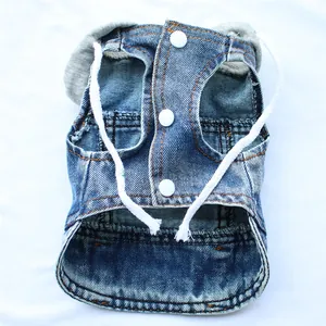 Detailed view of a blue denim pet vest with white snap buttons and a grey hood detail