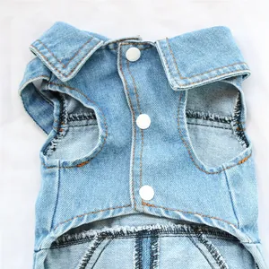 Close-up of a blue denim dog vest featuring white snap buttons and a neat collar.
