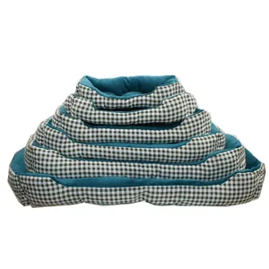 Stack of various sized pet beds with green checkered pattern and soft teal interior