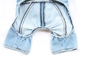 Close-up of internal stitching and elastic leg cuffs on denim pet overalls