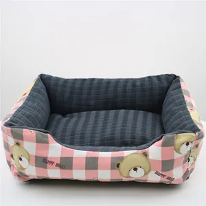 Comfortable pink checkered pet bed with cute bear pattern and soft grey interior