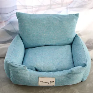 Close-up of a cozy light blue pet sofa bed with a removable cushion and brand label.