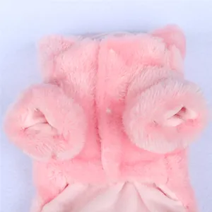 Detailed close-up view of a pink faux fur dog coat with warm soft fleece lining