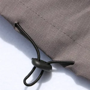 Macro detail of adjustable drawstring toggle and grey waterproof fabric for pet dog jacket