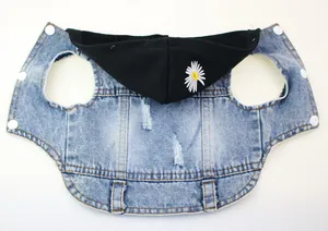 Close-up of a blue denim pet vest with a black hood and daisy embroidery detail