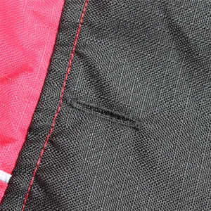 Close-up detail of reinforced leash attachment opening on waterproof pet jacket for dogs