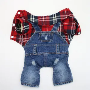 Macro view of a red plaid dog shirt attached to distressed blue denim overalls in flat lay style