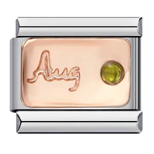 Macro shot of August birthstone Italian charm featuring embossed Aug text and green zircon.