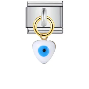 Macro view of heart-shaped blue Evil Eye charm on stainless steel Italian modular link
