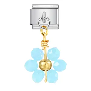 Dettaglio di un ciondolo a fiore in cristallo azzurro per bracciale modulare.