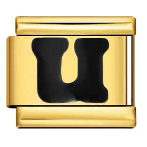 Close-up detail of a gold stainless steel Italian modular charm with black letter U