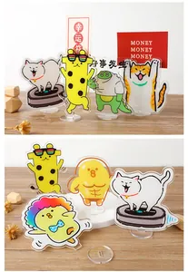 Detailed view of various cute acrylic animal message clips and memo holders on a desk