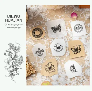 Artistic butterfly and floral patterns stamped on paper for DIY journaling decoration