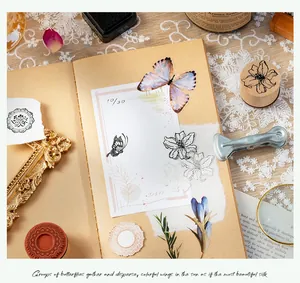 Detailed shot of creative wooden stamps with butterfly motifs on vintage journal