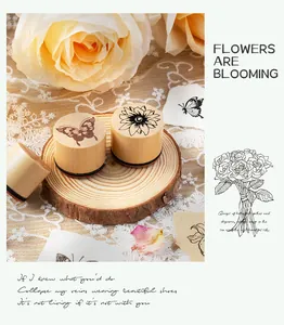 Close-up of wooden cylindrical stamps with detailed butterfly and flower patterns