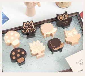 Detailed view of forest-themed wooden memo clips shaped like hedgehogs and owls