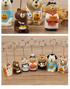 Detailed view of seven cute resin animal memo holders on a wooden desk environment
