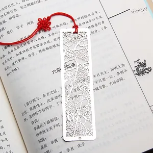 Traditional Chinese style hollow stainless steel bookmark with red tassel on book