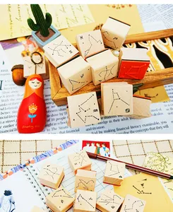 Set of creative wooden zodiac constellation stamps for DIY journals and scrapbooks.