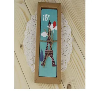 Detail of vintage Eiffel Tower bookmarks in a kraft paper gift box with twine.