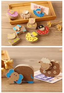 Close-up view of cute wooden animal shaped card holders for desk memo organization
