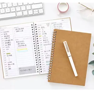 A5 kraft spiral notebook with daily and monthly planner layout for enhanced work productivity.