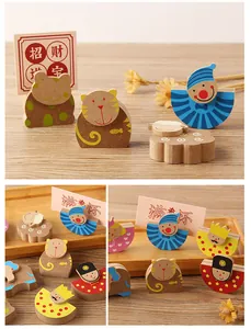 Detailed close-up of various cute cartoon animal wooden memo holders on a wooden tray