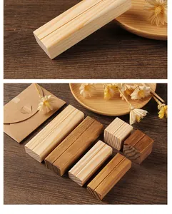 Detailed view of rustic wooden place card holders with natural wood textures and finishes