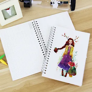 A5 spiral monthly planner notebook with watercolor girl illustration on the cover.