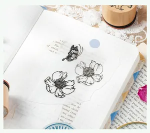 Detailed view of butterfly and flower stamp patterns on translucent vellum paper